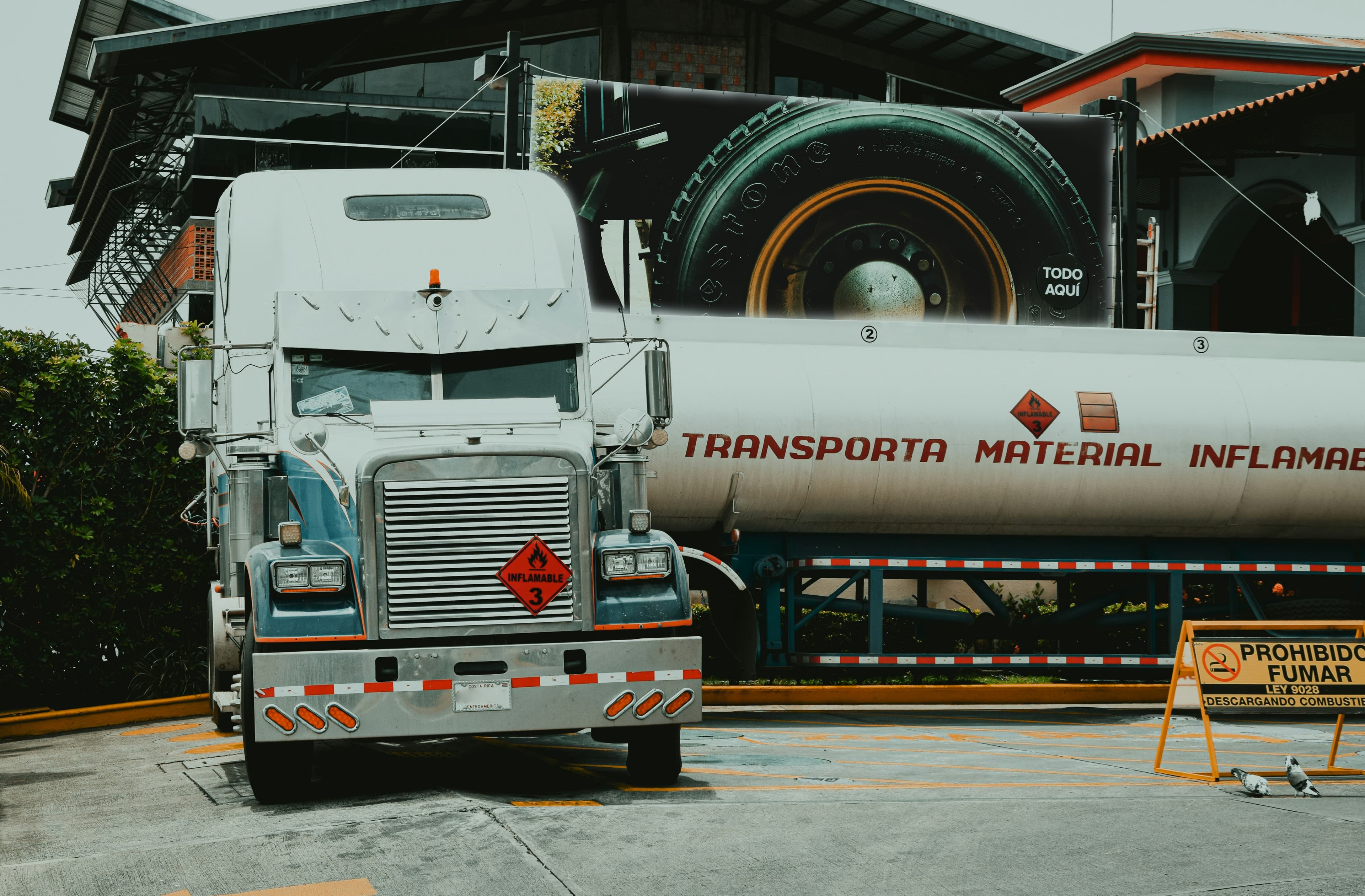 Conventional tractor and fuel tanker marked for flammable cargo in Spanish