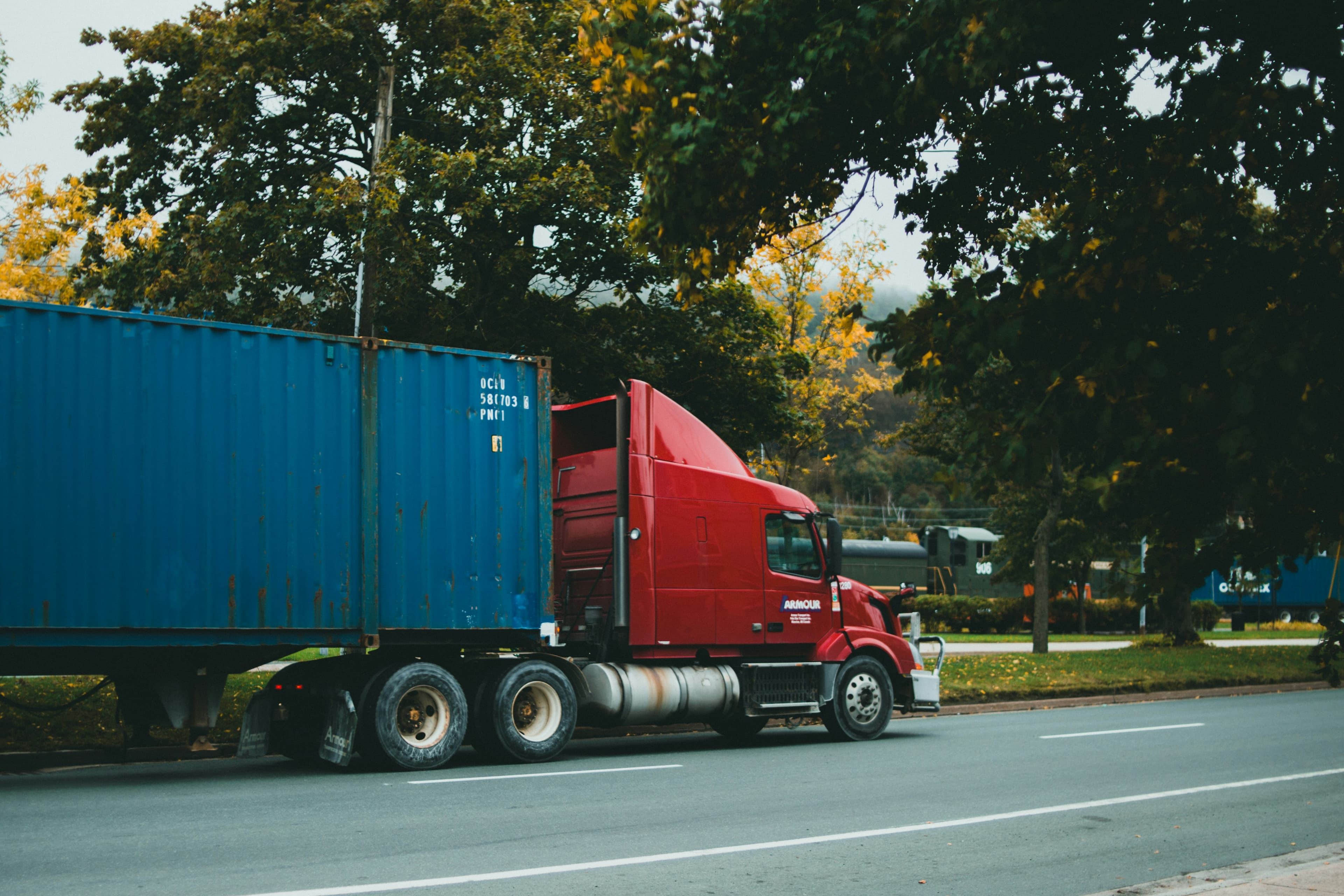 Day-cab tractor pulling an ocean container on a chassis