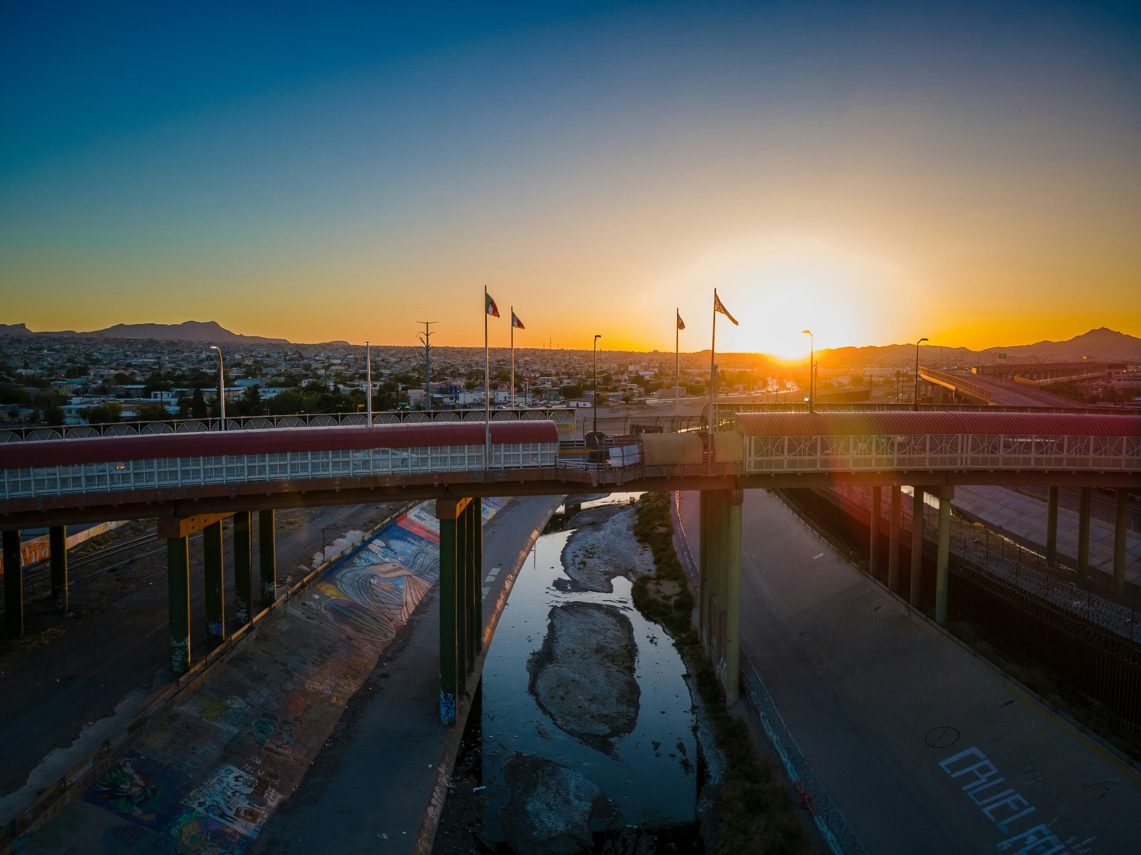 Sunset over an international bridge and the Rio Grande channel at El Paso
